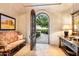 Foyer with elegant seating, a large mirror, and views to a garden at 10719 E Rimrock Dr, Scottsdale, AZ 85255