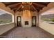 Covered patio with fireplace and mountain views at 10719 E Rimrock Dr, Scottsdale, AZ 85255