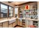 Charming kitchen with farmhouse sink, white cabinetry, and open shelving at 10719 E Rimrock Dr, Scottsdale, AZ 85255