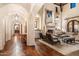 Hallway with hardwood floors and arched doorways leading to living area at 10719 E Rimrock Dr, Scottsdale, AZ 85255