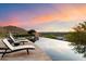 Infinity pool overlooking scenic mountain and sunset views at 10719 E Rimrock Dr, Scottsdale, AZ 85255