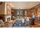Home office with built-in bookshelves, fireplace, and backyard access at 10719 E Rimrock Dr, Scottsdale, AZ 85255
