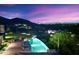 Infinity pool overlooking city lights at sunset at 10719 E Rimrock Dr, Scottsdale, AZ 85255