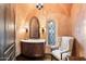 Charming powder room with ornate mirror and unique wallcovering at 10719 E Rimrock Dr, Scottsdale, AZ 85255