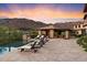 Relaxing pool area with lounge chairs and a covered patio at 10719 E Rimrock Dr, Scottsdale, AZ 85255