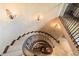 Elegant spiral staircase with wrought iron railings at 10719 E Rimrock Dr, Scottsdale, AZ 85255