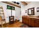 Bathroom with wooden vanity, ladder towel rack, and hardwood floor at 10719 E Rimrock Dr, Scottsdale, AZ 85255