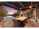Pergola-covered patio with dining table and seating at 10719 E Rimrock Dr, Scottsdale, AZ 85255
