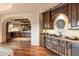 Custom wet bar with wood cabinetry and copper sink at 10719 E Rimrock Dr, Scottsdale, AZ 85255