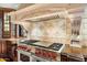 Upscale kitchen featuring professional-grade range and custom backsplash at 10719 E Rimrock Dr, Scottsdale, AZ 85255