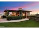 Stone outdoor kitchen with pergola and landscaping at 10719 E Rimrock Dr, Scottsdale, AZ 85255