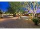 Elegant home exterior with stone accents and landscaping at 10719 E Rimrock Dr, Scottsdale, AZ 85255