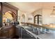 Modern home bar with stainless steel sink and ample storage at 10719 E Rimrock Dr, Scottsdale, AZ 85255