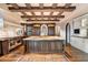 Large kitchen featuring a granite island and wood cabinetry, accented by exposed wooden beams at 10719 E Rimrock Dr, Scottsdale, AZ 85255