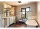 Spa-like bathroom with a freestanding tub and custom cabinetry at 10719 E Rimrock Dr, Scottsdale, AZ 85255