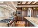 Gourmet kitchen with wood cabinetry, granite island, and high-end appliances at 10719 E Rimrock Dr, Scottsdale, AZ 85255