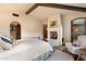 Serene bedroom with fireplace and access to private patio at 10719 E Rimrock Dr, Scottsdale, AZ 85255