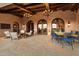 Large covered patio with multiple seating areas and access to the home at 10719 E Rimrock Dr, Scottsdale, AZ 85255