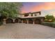 Three-car garage with arched entryways, showcasing the home's architectural style at 10719 E Rimrock Dr, Scottsdale, AZ 85255