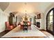 Elegant dining room featuring a large table, fireplace, and access to the outdoors at 10719 E Rimrock Dr, Scottsdale, AZ 85255