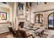 Cozy living room with a fireplace and access to the patio at 10719 E Rimrock Dr, Scottsdale, AZ 85255