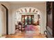 Living room with hardwood floors, arched entry, and comfortable seating at 10719 E Rimrock Dr, Scottsdale, AZ 85255