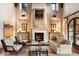 Spacious living room with a large stone fireplace and views at 10719 E Rimrock Dr, Scottsdale, AZ 85255