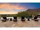 Infinity pool with multiple lounge chairs and mountain views at 10719 E Rimrock Dr, Scottsdale, AZ 85255