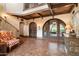 Elegant entryway with a curved staircase and tile flooring at 10719 E Rimrock Dr, Scottsdale, AZ 85255