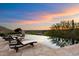 Infinity pool with lounge chairs, offering stunning sunset views at 10719 E Rimrock Dr, Scottsdale, AZ 85255