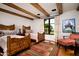 Bedroom with twin beds, hardwood floors, and large window at 10719 E Rimrock Dr, Scottsdale, AZ 85255