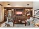 Large living room with built-in entertainment center and comfortable seating at 10719 E Rimrock Dr, Scottsdale, AZ 85255