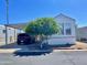 Single-wide manufactured home with carport and landscaping at 7750 E Broadway Rd # 10, Mesa, AZ 85208