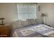 Cozy bedroom with floral bedding and window blinds at 7750 E Broadway Rd # 10, Mesa, AZ 85208