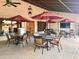 Outdoor patio area with tables, chairs, and umbrellas at 7750 E Broadway Rd # 10, Mesa, AZ 85208