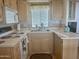 Galley kitchen with light wood cabinets and standard appliances at 7750 E Broadway Rd # 10, Mesa, AZ 85208