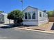 Mobile home with large window and landscaping at 7750 E Broadway Rd # 10, Mesa, AZ 85208