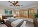 Spacious main bedroom with wood-look floors, large windows, and ceiling fan at 9985 E Legend Ct, Gold Canyon, AZ 85118