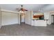 Open living room with wood-look floors and access to kitchen at 9985 E Legend Ct, Gold Canyon, AZ 85118