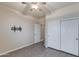 Bedroom with wood-look floors, double door closet, and ceiling fan at 9985 E Legend Ct, Gold Canyon, AZ 85118