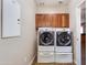 Laundry room with washer, dryer, and wood cabinets at 9985 E Legend Ct, Gold Canyon, AZ 85118