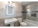 Updated bathroom with a walk-in shower, modern vanity, and gray tile at 3708 E Joan De Arc Ave, Phoenix, AZ 85032