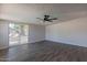 Bright living room featuring wood-look floors and sliding glass door to backyard at 3708 E Joan De Arc Ave, Phoenix, AZ 85032