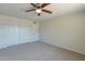 Well-lit bedroom with double-door closet and ceiling fan at 3708 E Joan De Arc Ave, Phoenix, AZ 85032