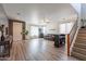 Open concept living area with hardwood floors and a staircase at 14760 W Riviera Dr, Surprise, AZ 85379