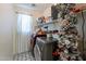 Functional laundry room with washer, dryer, and shelving at 14760 W Riviera Dr, Surprise, AZ 85379