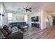 Spacious living room with a large sectional sofa and wood-look floors at 14760 W Riviera Dr, Surprise, AZ 85379