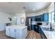 Kitchen island with white cabinets and stainless steel appliances at 14760 W Riviera Dr, Surprise, AZ 85379