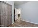Bedroom with barn door closet and wood-look floors at 14760 W Riviera Dr, Surprise, AZ 85379