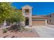 Two-story home with welcoming front porch and landscaping at 14760 W Riviera Dr, Surprise, AZ 85379